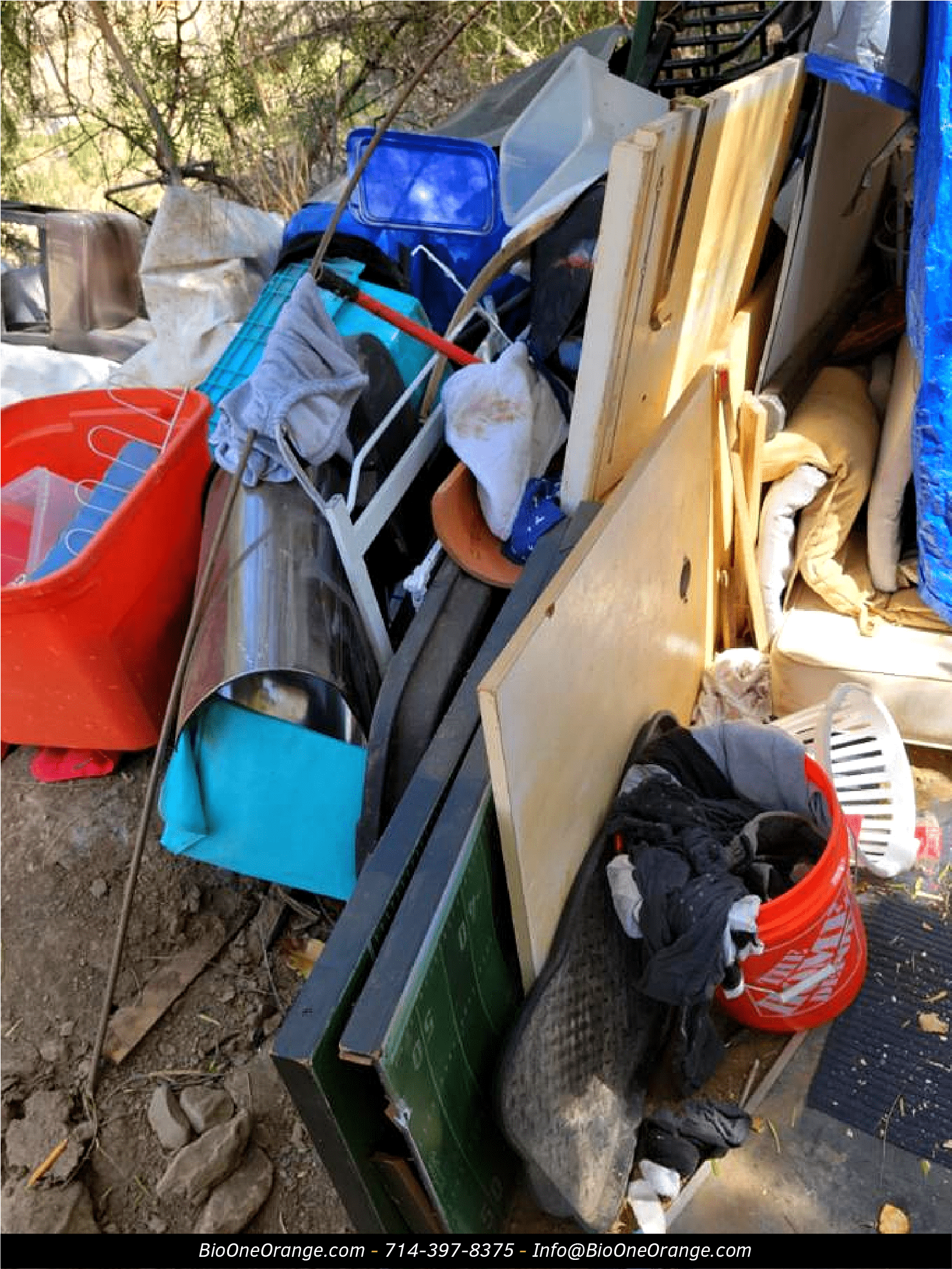 Image shows various objects found in encampment site near a residential neighborhood.