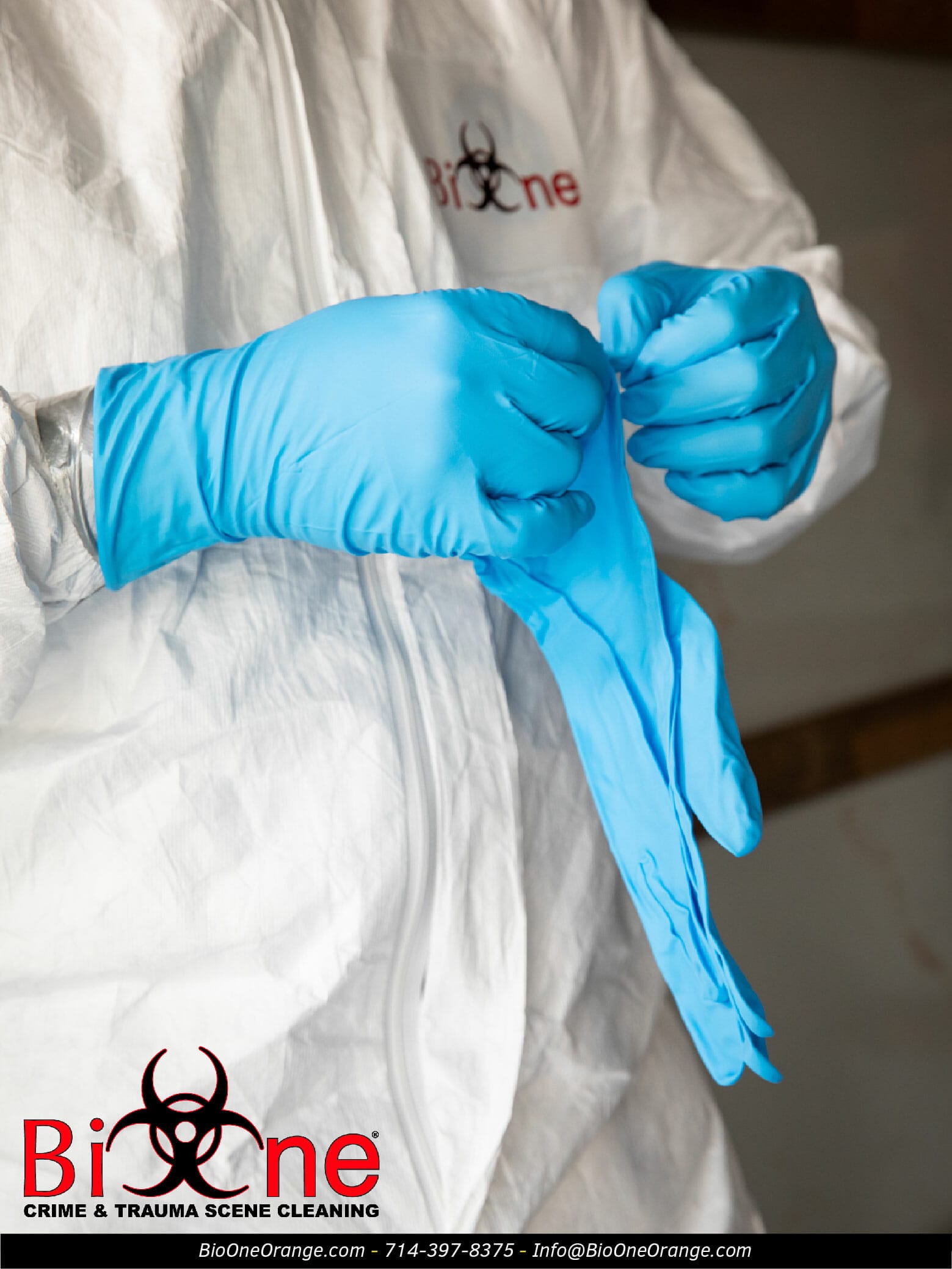 Image shows Bio-One restoration technician wearing nitrile gloves (PPE).